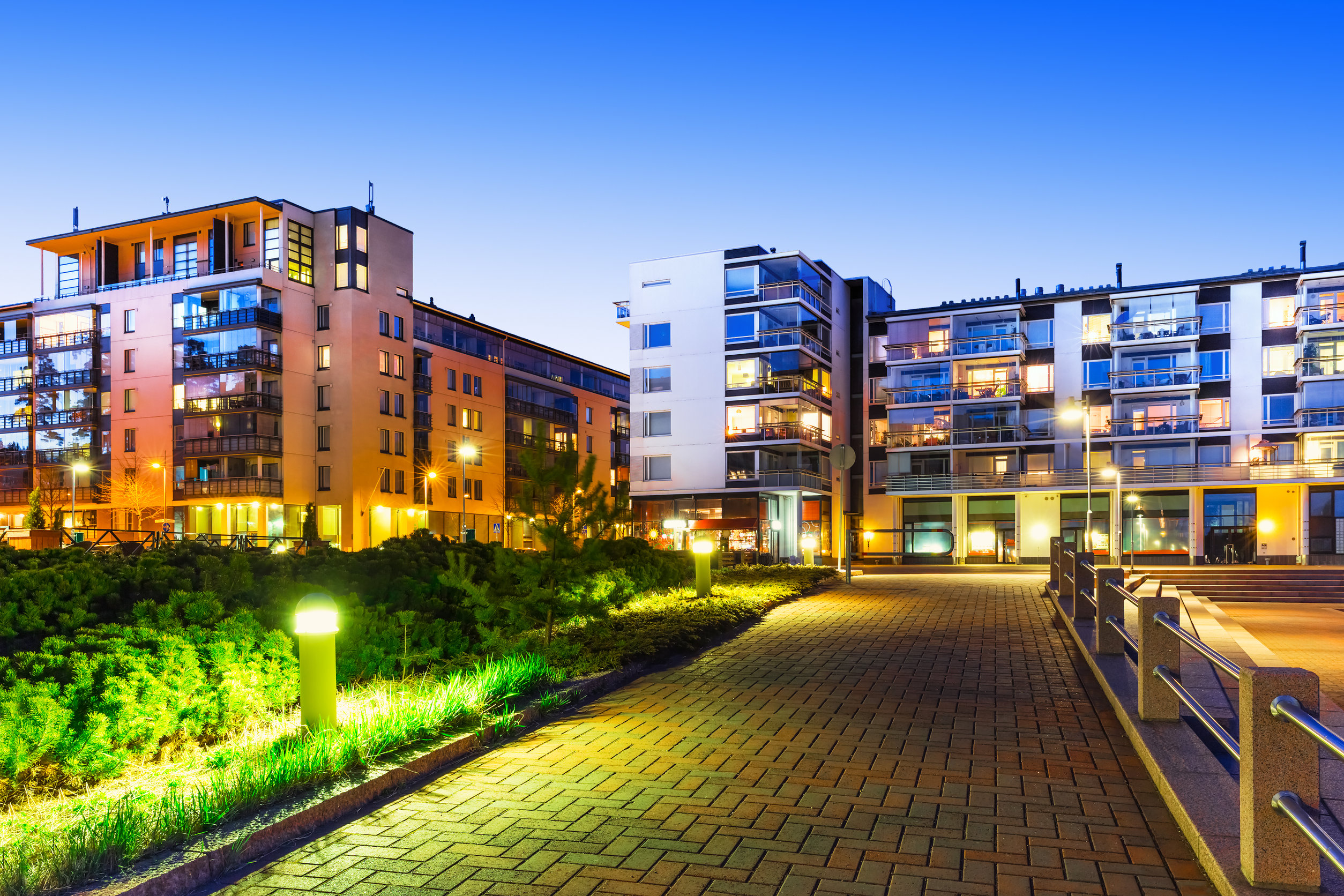 House building and city construction concept: evening outdoor urban view of modern real estate homes